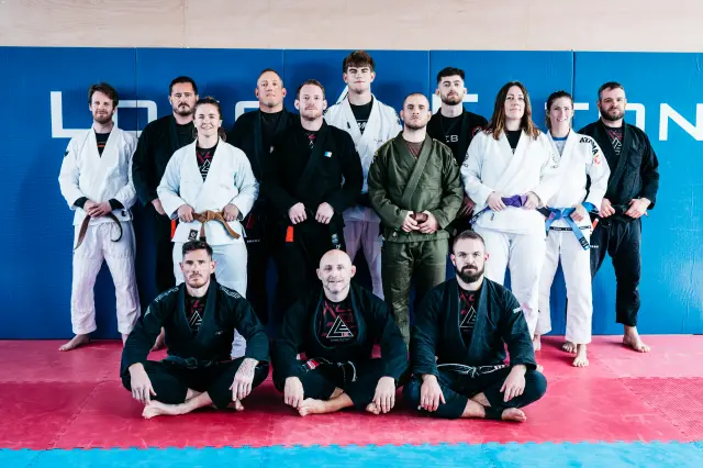 Long Eaton BJJ instructors posing for a group photo in the gym
