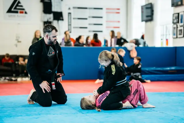 An instructor demonstrating BJJ technique during class at Long Eaton BJJ