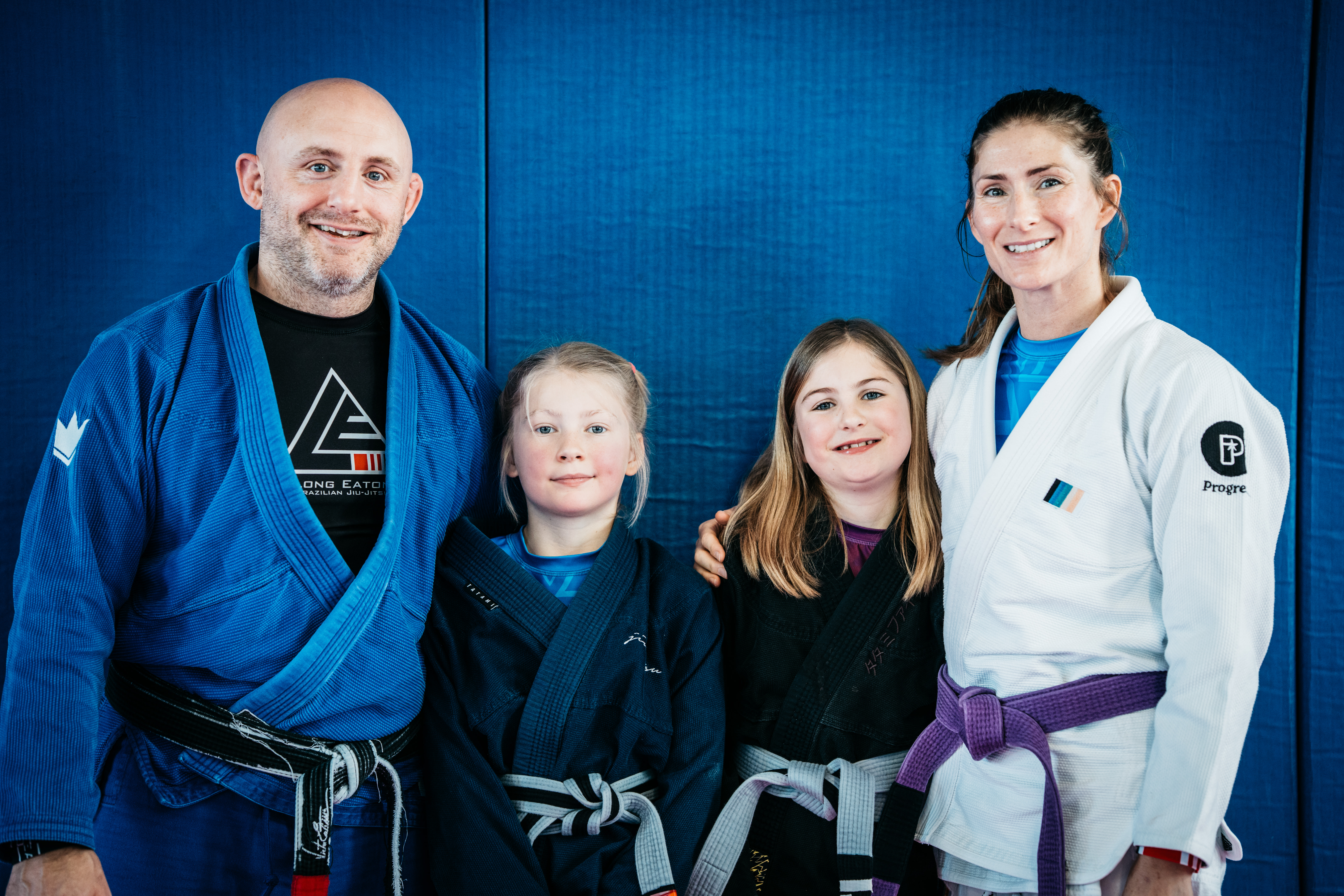 Two instructors and two junior students posing together in the academy