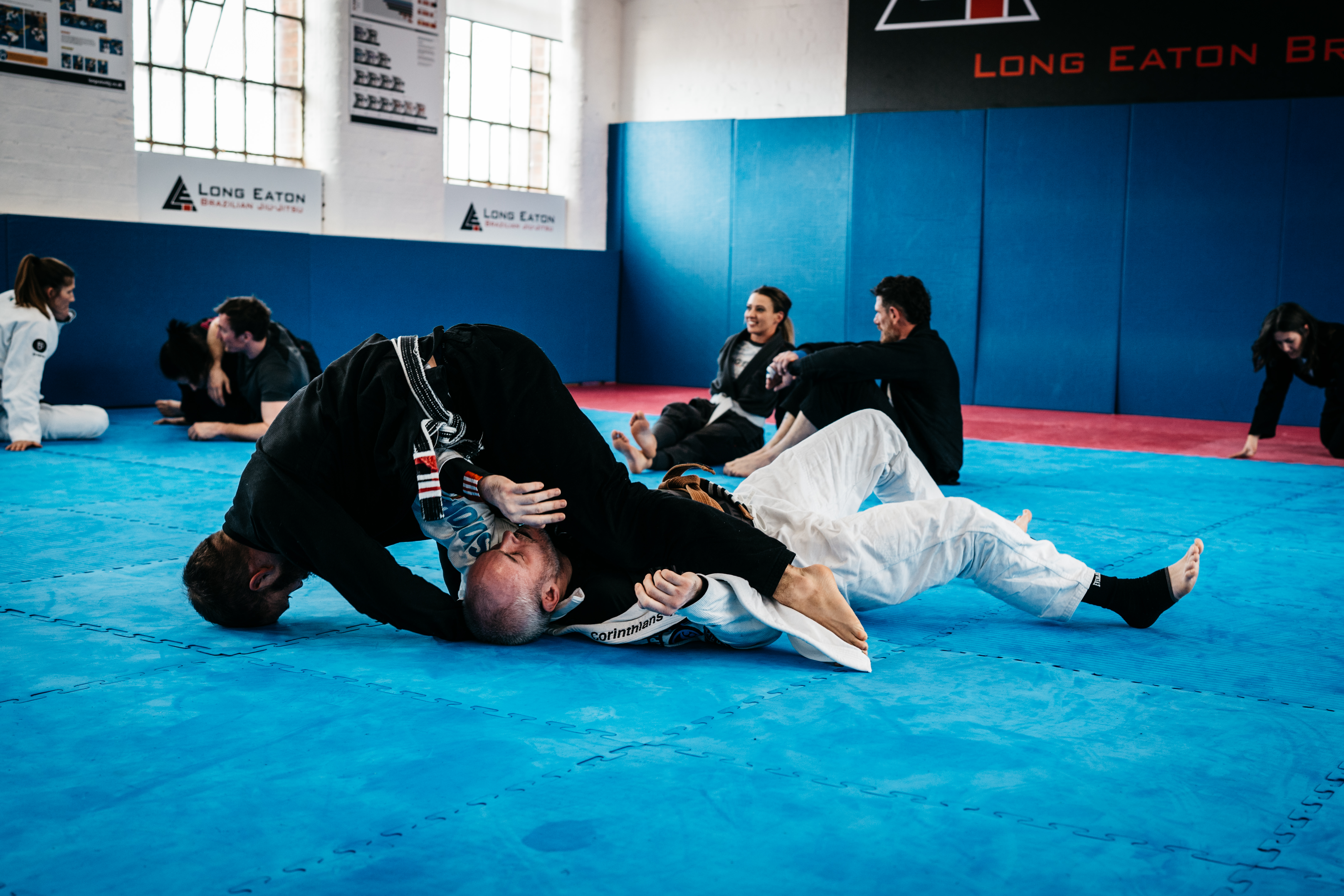 Two students engaged in a controlled sparring session during class at Long Eaton BJJ
