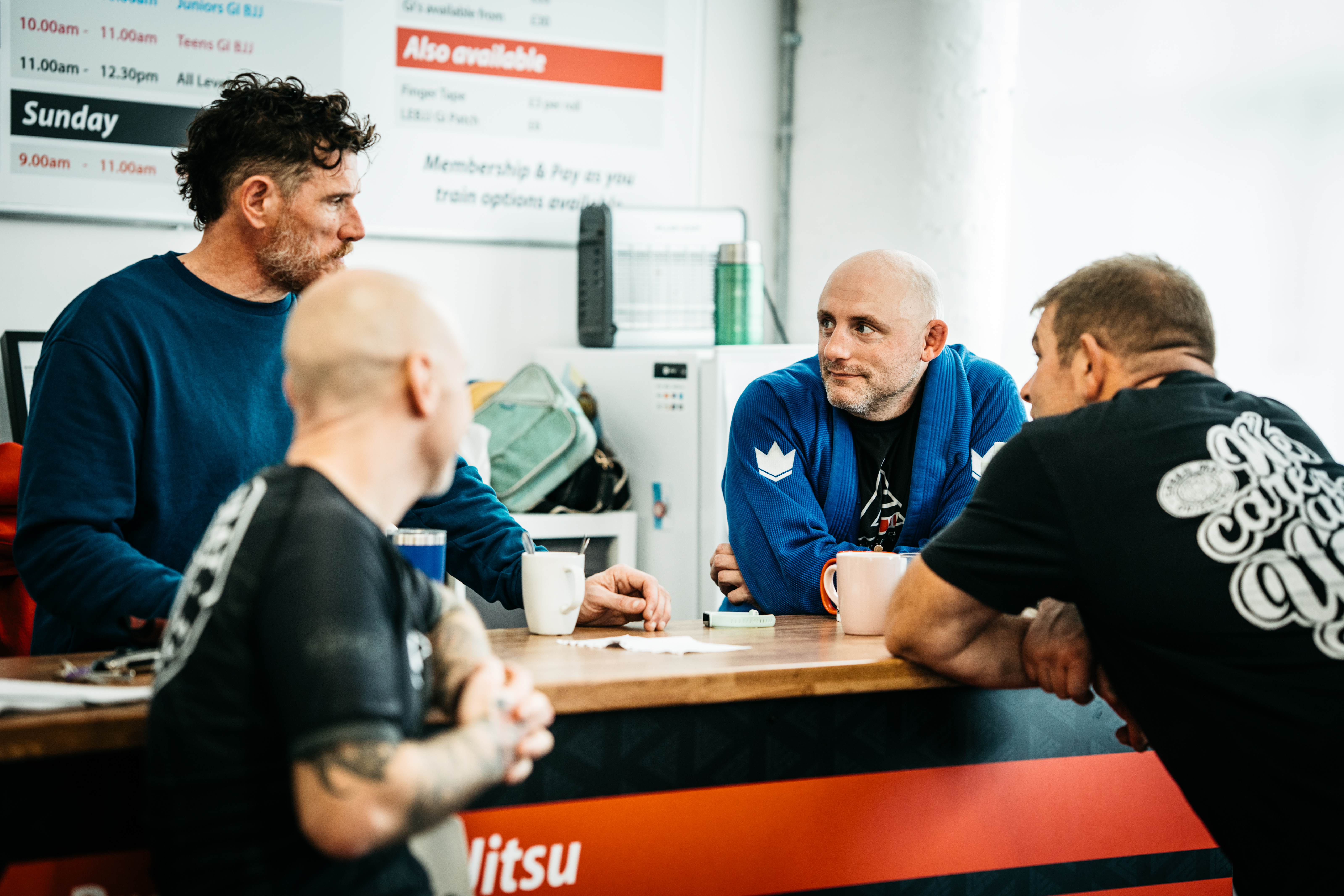 Students taking a break and enjoying a coffee together at Long Eaton BJJ