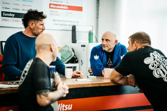 Students taking a break and enjoying a coffee together at Long Eaton BJJ